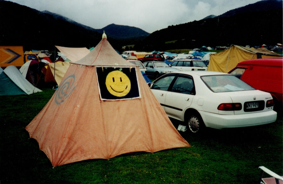 Campsite tent with a painted acid-house smiley
